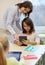 Little girl with teacher and tablet pc at school