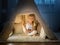 Little girl in teepee tent in room