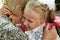 Little girl tenderly embraces grandmother in day back to school