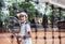 Little girl with tennis racket in sport club. Cropped image of a sporty little girl with racket playing tennis outdoors. Child