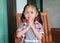 Little Girl Thailand`s Respect `Sawatdee` sitting on the wooden chair