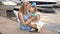 Little girl three years sitting on the lap of the mother with long blond hair