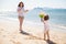 Little girl throwing beach ball