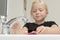 Little Girl About to Wash Toothbrush at Bathroom Sink