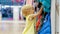 Little girl touching clothes in childrens clothing store during family shopping