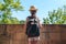 Little girl traveler in a straw hat with a backpack