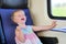 Little girl traveling by train