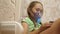 Little girl treated with an inhalation mask on her face in hospital. child with a tablet is sick and breathes through an