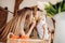 Little girl treats her mother to an apple at the kitchen