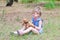 A little girl treats her teddy bear in a forest glade a copy of