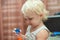 A little girl tries to inflate soapy water balls. Child and soap bubbles