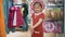 Little girl try on a hat and bag in a store, have fun and smiling. Kids shopping