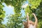 Little girl try to catch heart on a tree