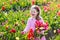 Little girl in tulip flower garden