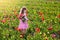 Little girl in tulip flower garden