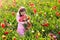 Little girl in tulip flower garden