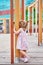 A little girl with two tails plays hide and seek on the Playground