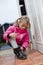 Little girl tying her shoes
