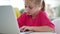 Little girl typing on laptop keyboard