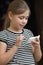 Little girl typing sms on a smartphone