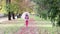 Little girl with umbrella walking in park