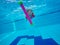 Little girl under water in pool.