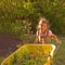 Little Girl Using Yellow Wheelbarrow