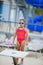 Little girl waiting to use the diving board during her swim lessons at the local outdoor pool in the summer