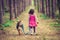 Little girl walking with dog