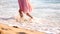 Little girl walking at sunrise on beautiful ocean beach. Happy summer vacation