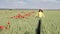 Little girl walking through a wheat field