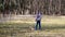 A little girl walks with a ginger striped cat on a leash in a park on a spring day. The concept of love for pets