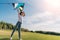 Little girl wanting to launch a kite on green lawn