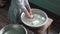 A little girl washes dishes in a dirty pelvis in the Village