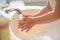 Little girl washing hands at the bathroom sink