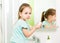 Little girl washing hands and showing soapy palms