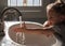 Little girl washing her hands in the bathroom sink