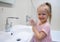 Little girl washing her hands with soap