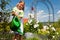 Little girl watering flowers