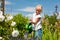 Little girl watering flowers