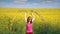 little girl waving with colorful ribbons on field