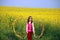 Little girl waving with colorful ribbons on field spring s