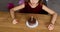 A little girl is wearing a birthday hat looking at a Birthday Cake and blow candles