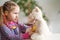 Little girl wearing in everyday clothes, using stethoscope on teddy bear