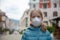A little girl, wearing a medical mask, empty town on the background