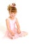 Little girl wearing pink ballet dress sitting