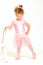 Little girl wearing a pink ballet outfit and dance