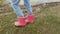 Little girl wearing rain boots in cold day near lake