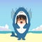 little girl wearing a shark costume character fright and got shocked isolated on a beach background. little girl wearing a shark