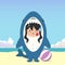 little girl wearing a shark costume character got a slap on the face isolated on a beach background. little girl wearing a shark